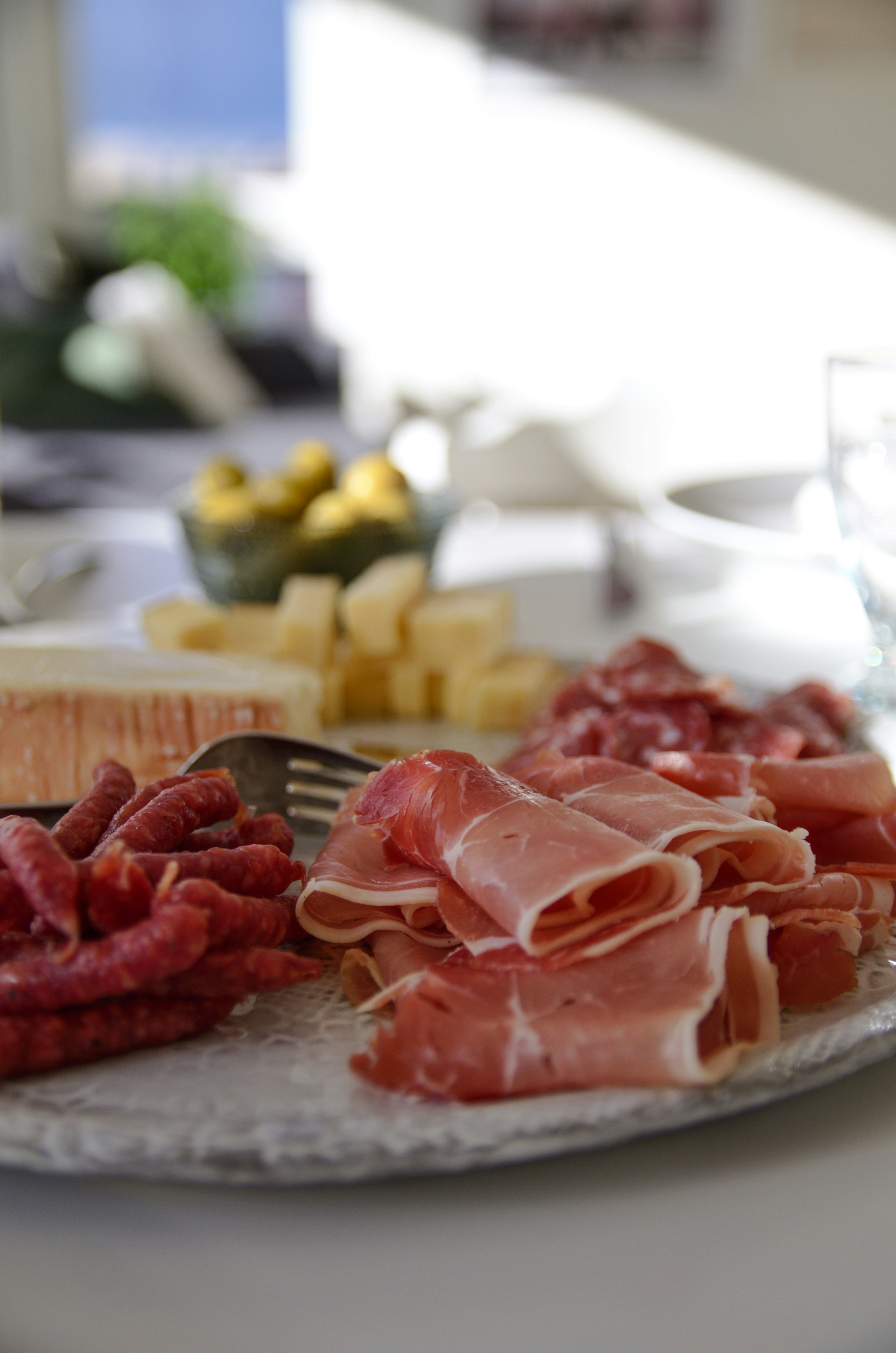 A platter of Norwegian spekemat with cured meats, cheese and flatbread
